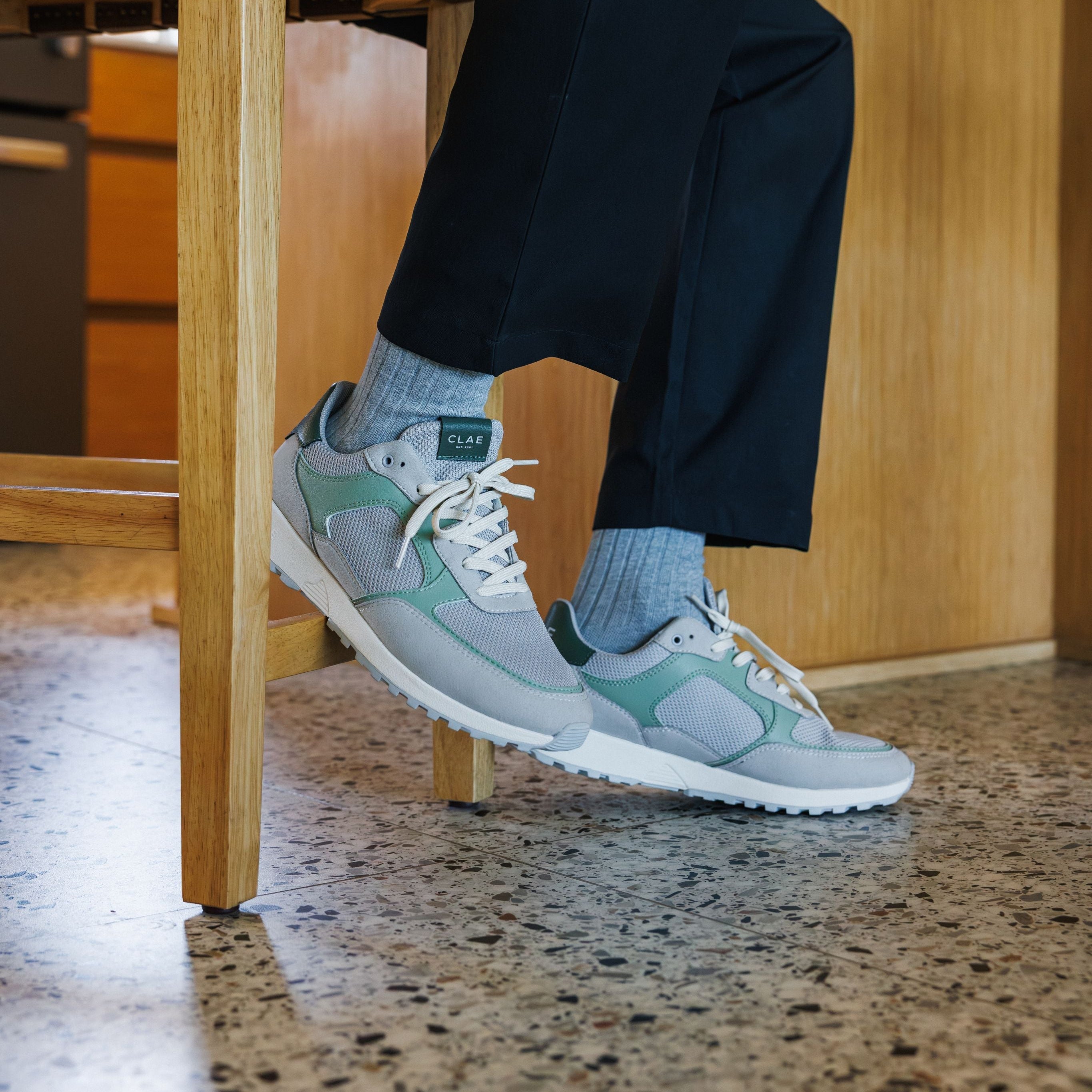 Joshua trainer in Quiet Gray Tea worn in casual lifestyle setting, showcasing comfort, cushioning, and eco-friendly materials.