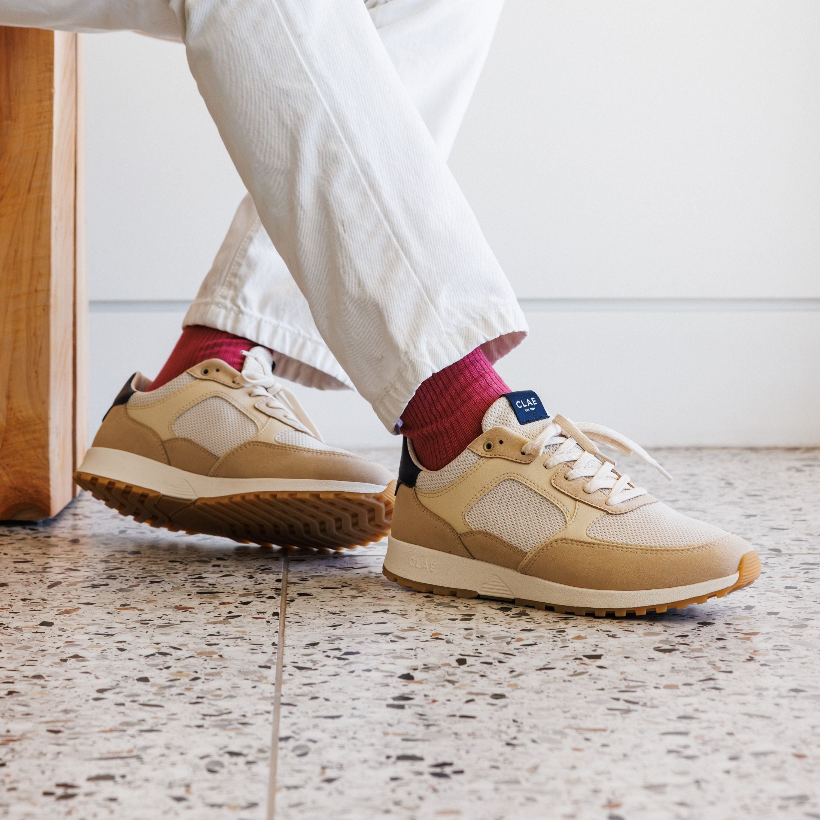 Joshua trainer in Safari Off-White worn in casual lifestyle setting, showcasing comfort, cushioning, and eco-friendly materials.
