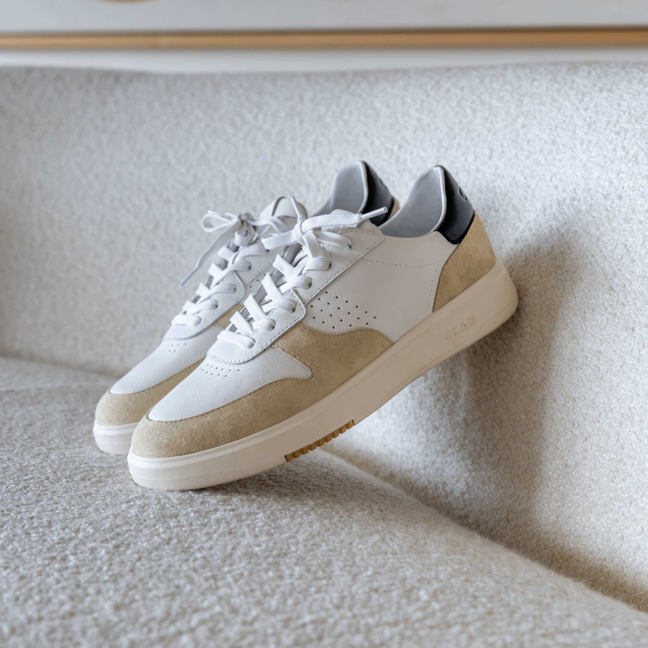 Top view of Moses sneaker in White Wood Ash Black, showing Italian leather and suede upper with sleek court-style design.
