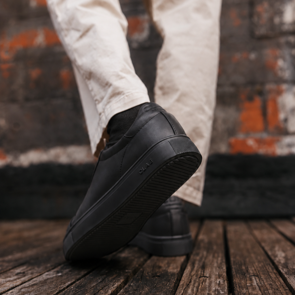 CLAE Bradley Essentials Triple Black Leather with black socks — lifestyle