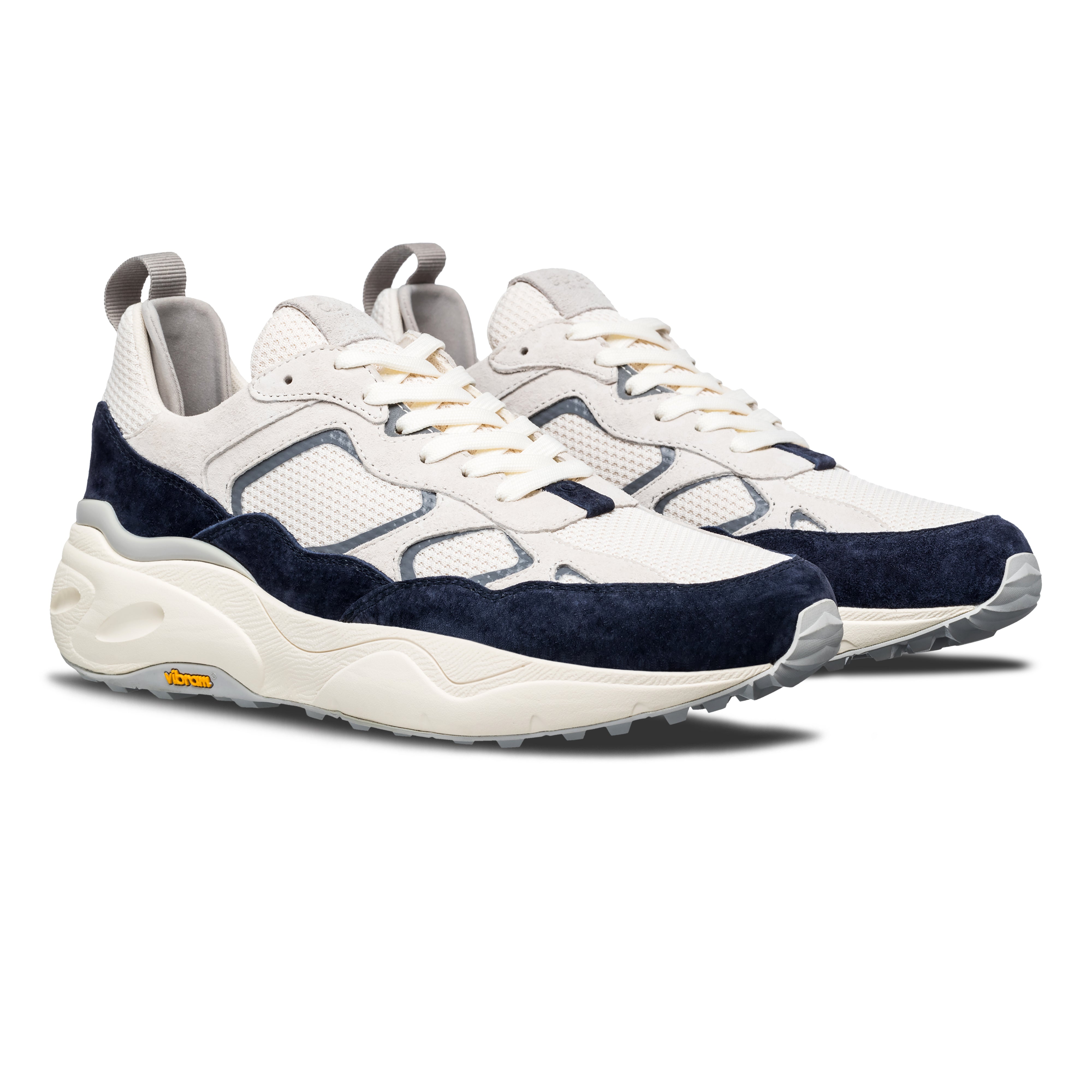 Three-quarter view of Salazar runner in Off-White Navy, highlighting flexible construction and modern premium design.