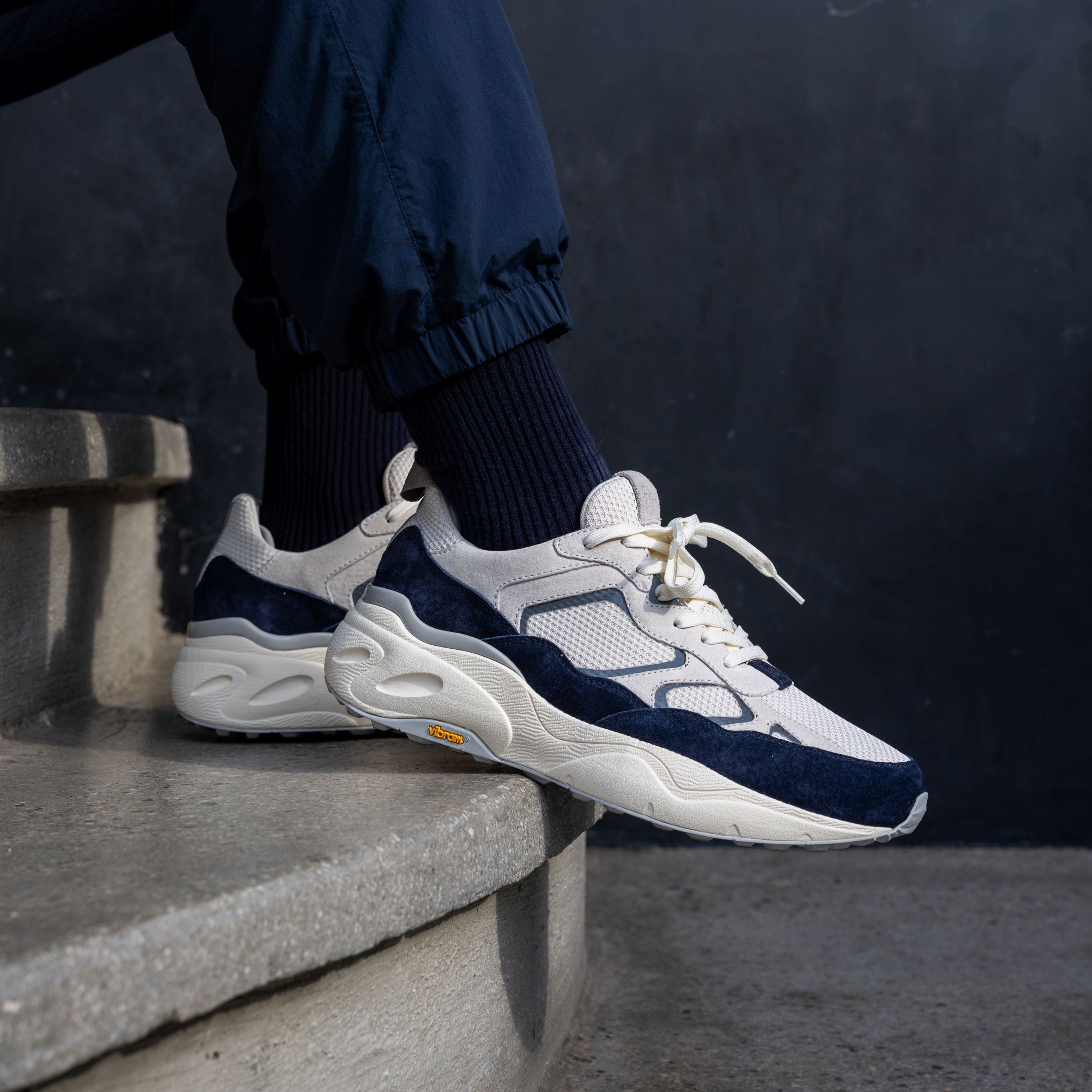 Salazar runner in Off-White Navy worn in casual lifestyle setting, highlighting lightweight, flexible construction and VIBRAM outsole.